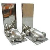 A pair of polished aluminium bookends, featuring 1920's racing cars. (2)