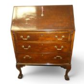 Mahogany bureau on ball and claw supports. Collection/courier only (H: 104cm x W: 75cm x D: 43cm)
