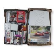 A mixed collection of motorsport books, F1 scrapbooks, photos, DVD's, VHS cassette tapes, ceramic