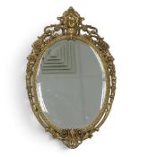 French Baroque Louis XV style metal wall mirror, with gold ornate floral and figural motifs. (H: