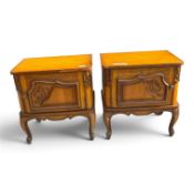 A pair of oak continental bedside cabinets, single left/right doors on cabriole legs. (H: 60cm) (2)