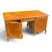 Continental-style carved oak partners desk, on cabriole legs, double cupboard storage with