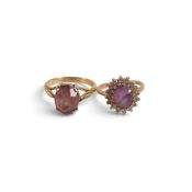 Two 9ct gold rings, each set with central oval amethyst stones, sizes N & K, 6.1g. (2)