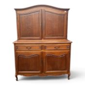 Carved oak continental house keepers cupboard, with curved top, adjustable internal shelving,