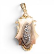 Victorian yellow metal pendant or locket, central floral motif adorned with white stones,