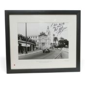Framed black and white photograph of John Surtees Ferrari 1965 Monaco GP, signed by John Surtees. (