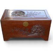 A 20th century Chinese carved storage trunk, H55cm x W101cm x D52cm.