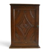 An Tabletop cabinet with hinged door , with diamond shaped panel to the door containing a floral