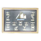 Framed and mounted behind glass depicting named various samples of knots together with a centre