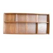 A mid-century Ercol wall mounted plate rack, H49cm x W107cm x D12cm.