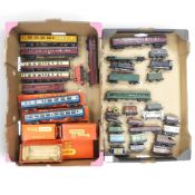 A collection of loose OO gauge steam locomotives, passenger carriages, goods vans, tankers from