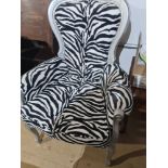 A modern chair having zebra style upholstery