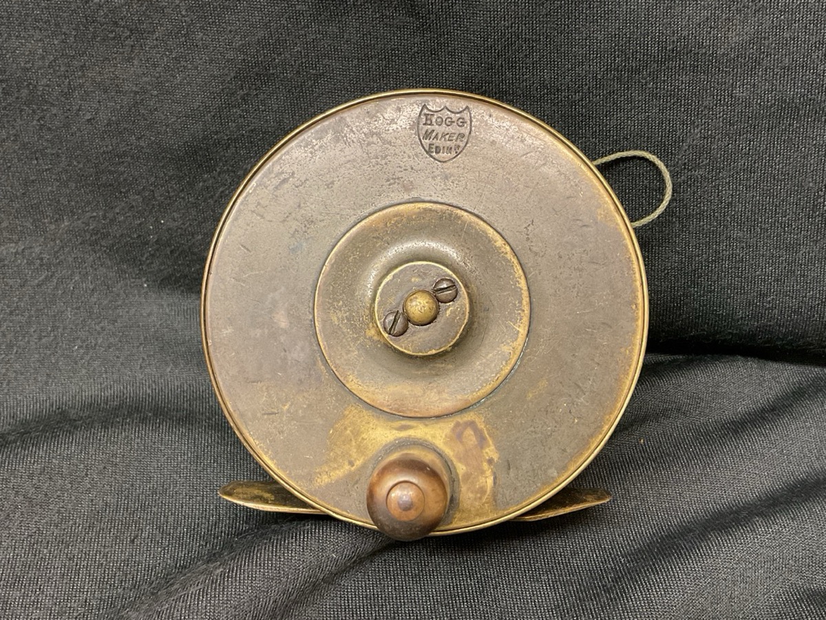 An antique brass Hogg of Edinburgh salmon fly reel with horn handle. (3.5in)