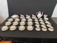 An Aynsley dinner service with blue & gilt borders in the Laurette pattern - tureen, sauceboats on