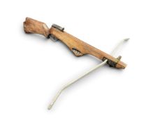 A crossbow with mahogany rifle style stock, having carved shaped foregrip and steel limbs. (36.5in x
