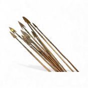 Group of ten Zulu war spears on wooden shafts.