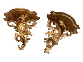 Pair of gilt wood wall brackets with scrolling foliate decoration, 26.5cm wide x 23cm high