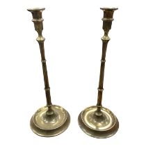 Pair of antique brass tall candlesticks with turned columns on circular bases