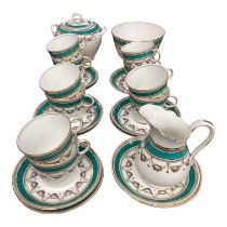 English porcelain ten place setting teaset with floral and turquoise borders
