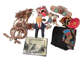 Sundry items, including two Indonesian carved and painted wood masks, embroideries, a Donald Trump d