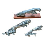 Group of three Jaguar cars leaper mascots, one mounted on a wooden base, (3).