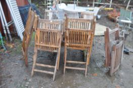 A ROYAL CRAFT DISTRESSED HARDWOOD EXTENDING GARDEN TABLE six folding chairs and a lounger extended