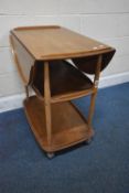 LUCIAN ERCOLANI, A MID-CENTURY ELM AND BEECH THREE TIER DROP LEAF TROLLEY, raised on cylindrical