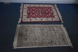 A RED GROUND WOOLLEN RUG, with repeating foliate patterns, surrounded by a multi-strap border, 142cm