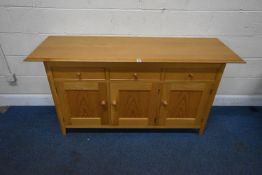 A MARKS AND SPENCER HOME LIGHT OAK SIDEBOARD, fitted with three drawers, the central drawer fitted
