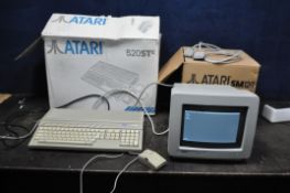 AN ATARI 520STE VINTAGE PERSONAL COMPUTER with original box, mouse (broken case) and a SM124 monitor
