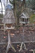 TWO WOODEN BIRD TABLES one with a conical thatch roof 185cm high and another (2)
