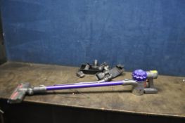 A DYSON V6 ANIMAL CORDLESS VACUUM CLEANER with accessories and wall bracket charger (PAT pass and