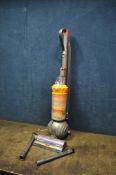 A DYSON LIGHT BALL UPRIGHT VACUUM CLEANER with some attachments (PAT pass and working)