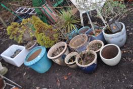 EIGHTEEN GLAZED PLANT POTS AND A BELFAST SINK, sink length 75cm, largest pot 49cm in diameter.