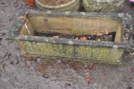 A RECTANGULAR CONCRETE PLANT in sarcophagus form with detail to all facets, 91cm long