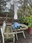 A HARDWOOD GARDEN BENCH 147cm wide, a hardwood folding table and two incomplete parasols (4)