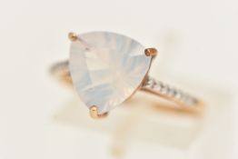 A 9CT GOLD GEM SET RING, set with a milky white triangular cut stone, flanked with small single