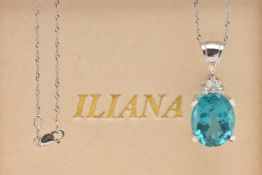 A BOXED 18CT WHITE GOLD GEM SET PENDANT AND 9CT WHITE GOLD CHAIN, set with a large oval cut blue
