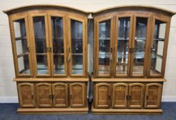 A PAIR OF WALL UNITS, each fitted with four glazed doors, atop a base with four cupboard doors,