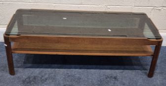 A MYER MID-CENTURY TEAK TWO TIER RECTANGULAR COFFEE TABLE, with a smoked glass top insert, width