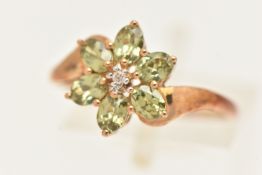A 9CT GOLD GEM SET CLUSTER RING, set with a small round brilliant cut diamond, in a surround of