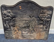 A LARGE CAST IRON FIRE BACK, depicting a man with his dog surrounded by trees, reading 'modele