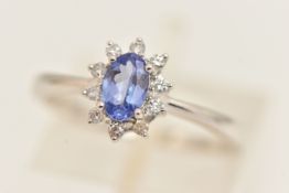 A PLATINUM TANZANITE AND DIAMOND CLUSTER RING, of an oval form, hallmarked platinum Birmingham