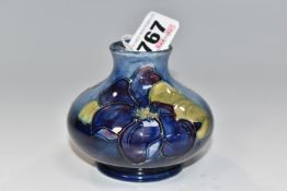 A MOORCROFT POTTERY 'CLEMATIS' PATTERN VASE, the squat baluster vase tube-lined with purple clematis
