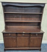 A STAG MINSTREL DRESSER, the three tier plate rack atop a base with three drawers, over three