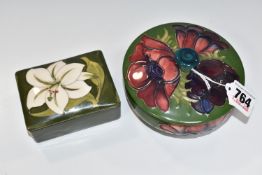 TWO MOORCROFT POTTERY COVERED POTS, comprising a rectangular covered pot in the tube lined design '