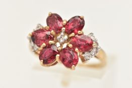 A 9CT GOLD GEM SET CLUSTER RING, set with oval cut red stones assessed as treated rubies, and
