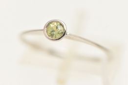 A 9CT WHITE GOLD GEM SET RING, a circular cut light green yellow stone assessed as sphene, in a