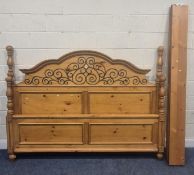 A MODERN PINE 6FT6 EMPEROR BEDSTEAD, with scrolled iron-work details to the headboard, siderails,