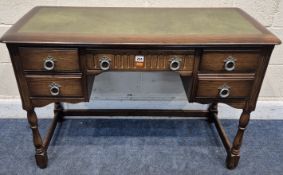 A LATE 20TH CENTURY OAK KNEE HOLE DESK, with a green leatherette writing surface, five assorted